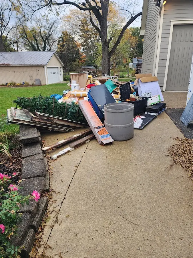 Dumpster being loaded with debris for Residential Dumpster Rental in Edgemere